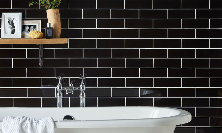 Jet Black Porcelanosa Wall Tile In Bathroom With Contrasting White Bath Tub